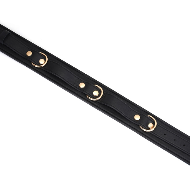 Wykwintne kajdanki na uda z licowej ścisłej skóry bydlęcej w kolorze głębokiej czerni z okuciami  z metalu w kolorze złota rozmiar M/L obwód max 81 cm